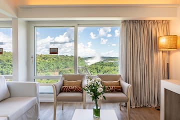 a room with a view of the mountains and trees
