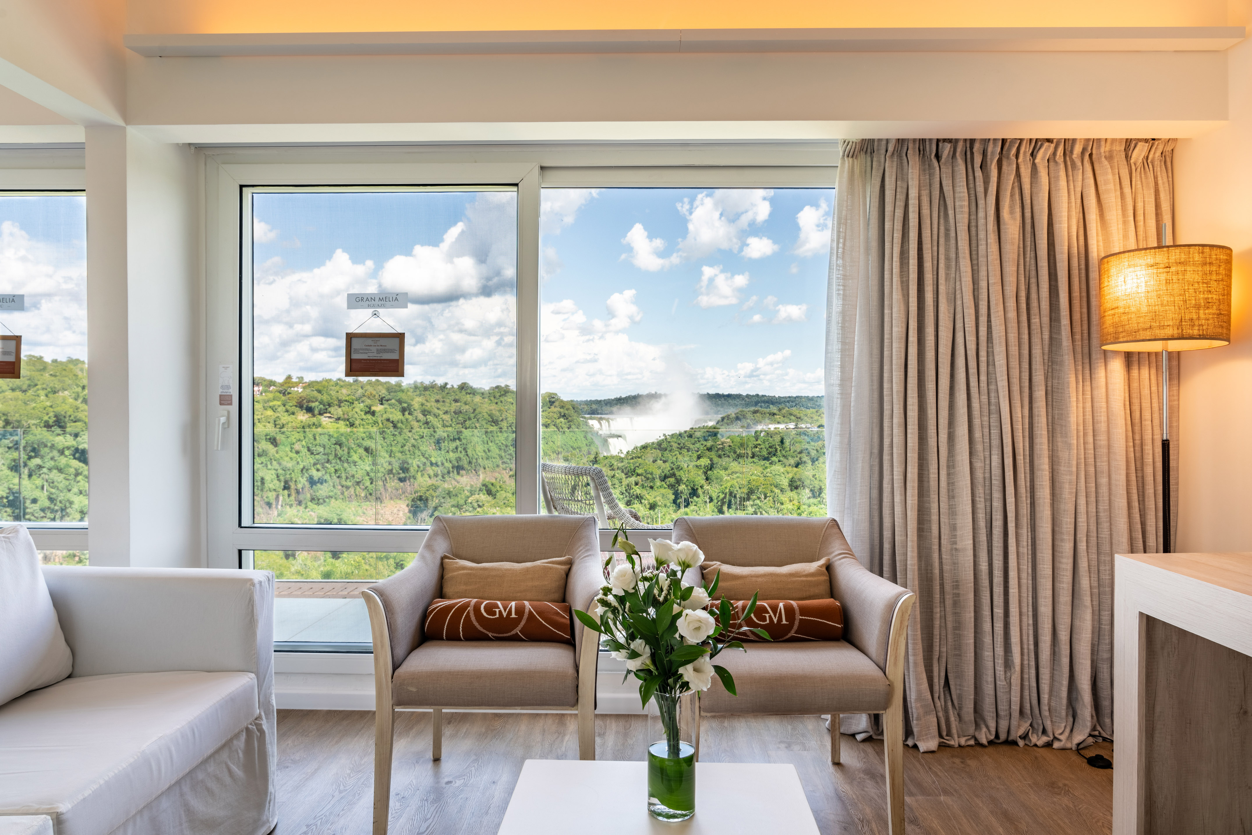 Gran Meliá Iguazú room with panoramic Iguazu Falls view and seating area.