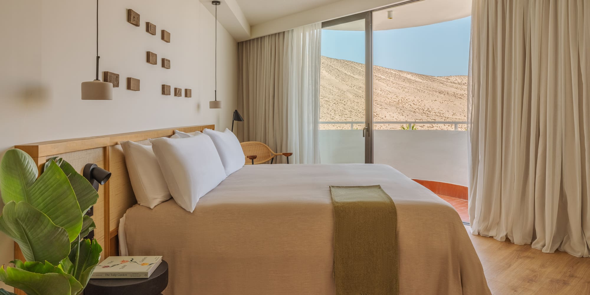 a bedroom with a bed and a plant