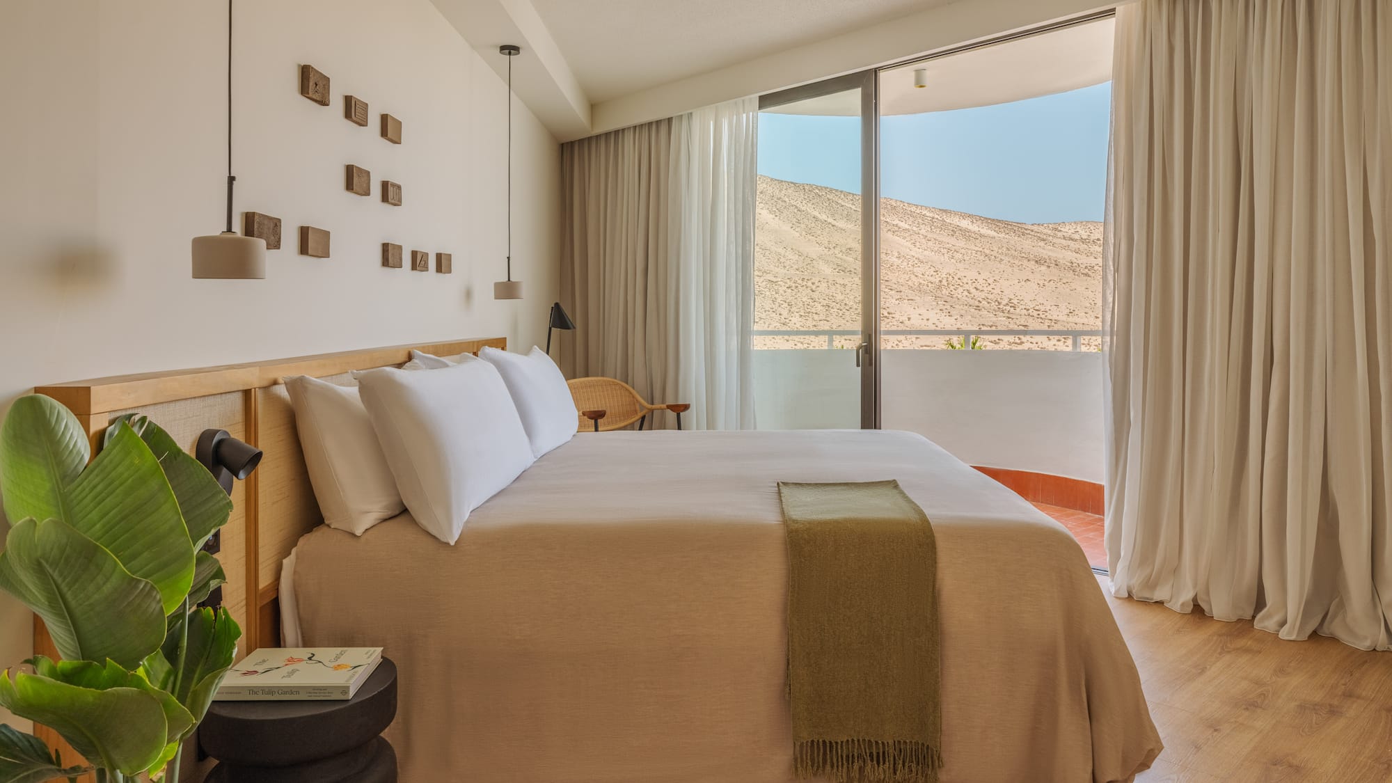 a bedroom with a bed and a plant