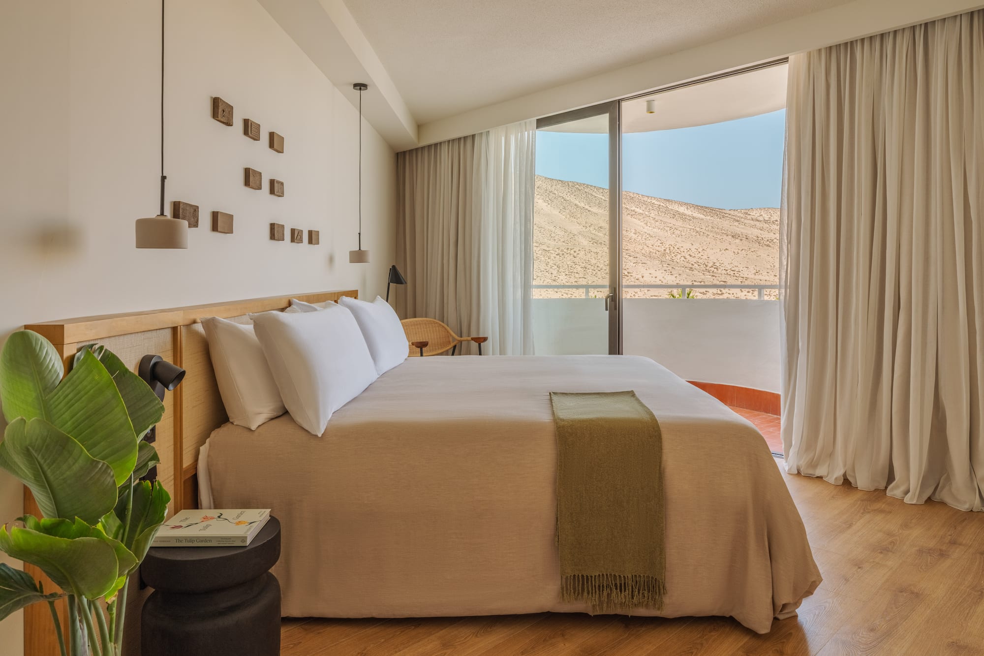 a bedroom with a bed and a plant