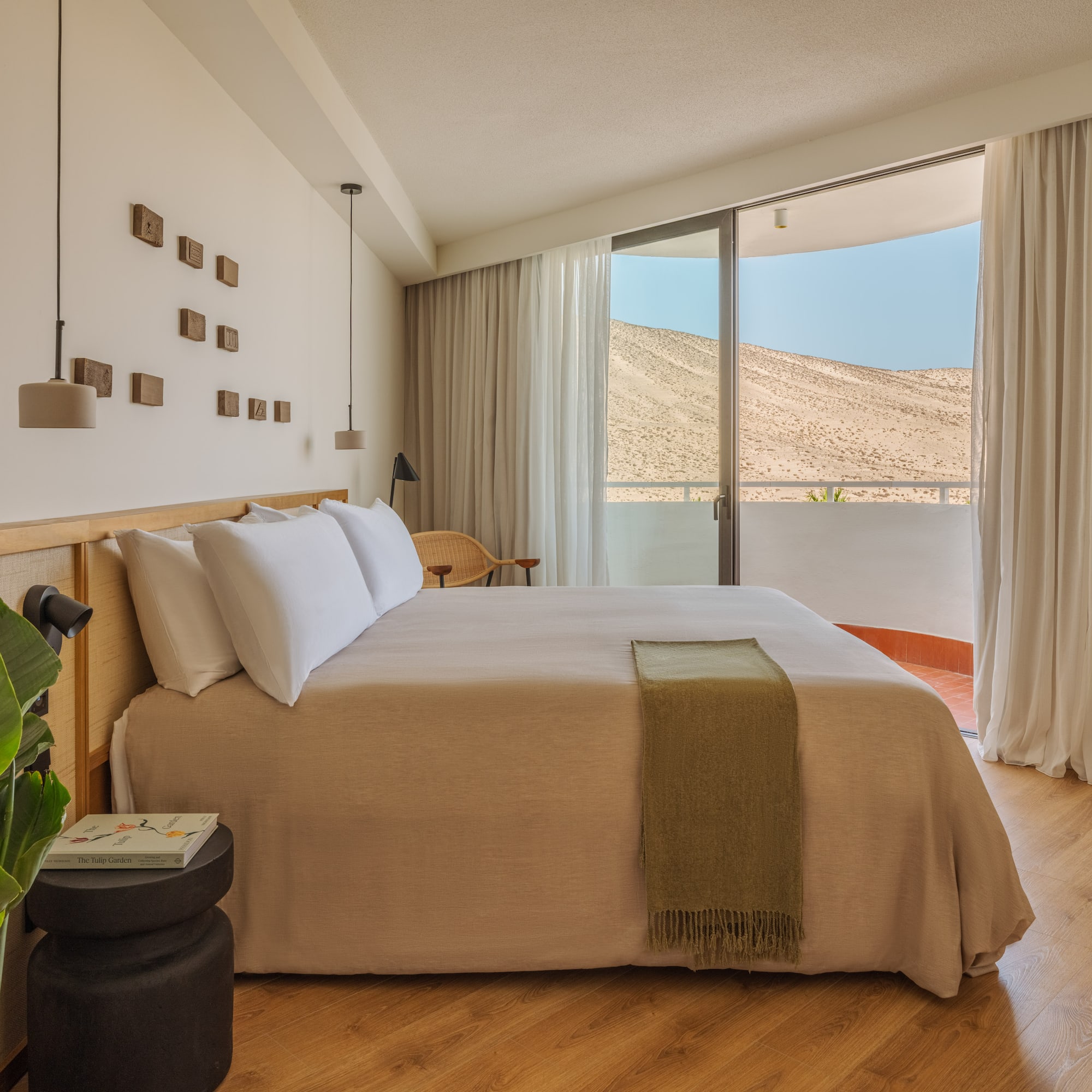 a bedroom with a bed and a plant