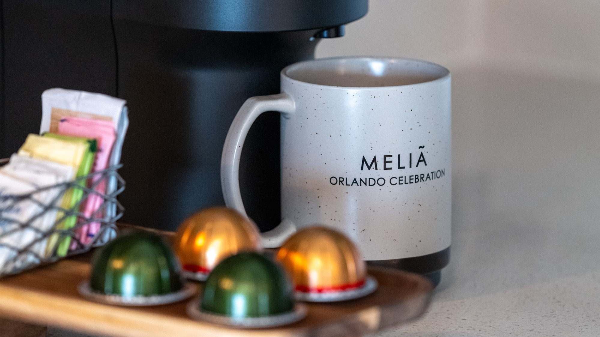 a coffee machine with a mug and some colorful capsules