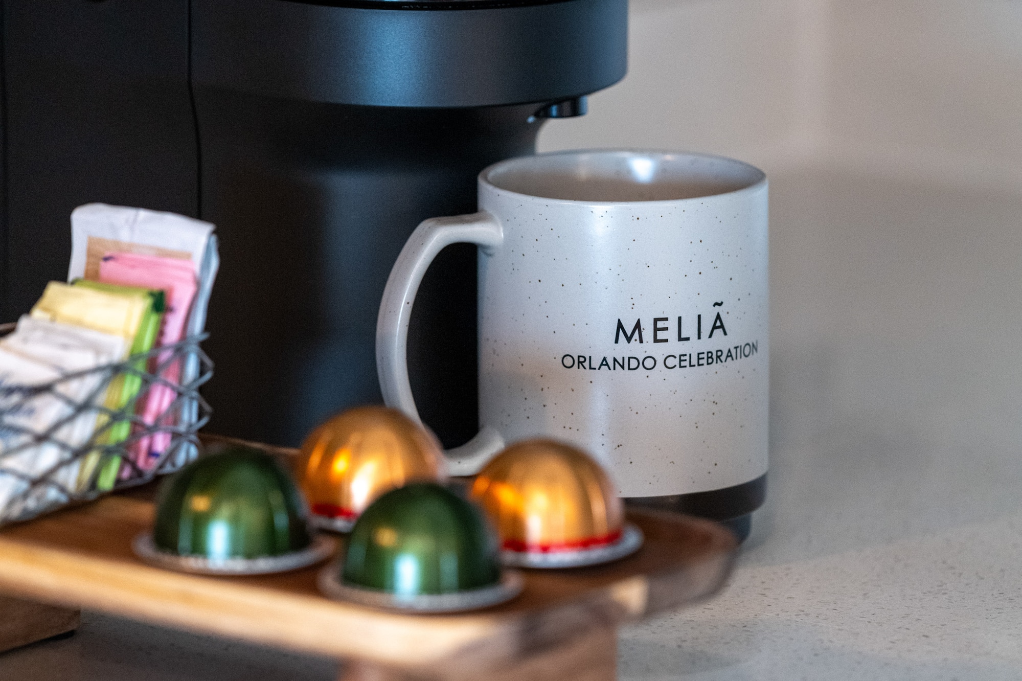 a coffee machine with a mug and some colorful capsules