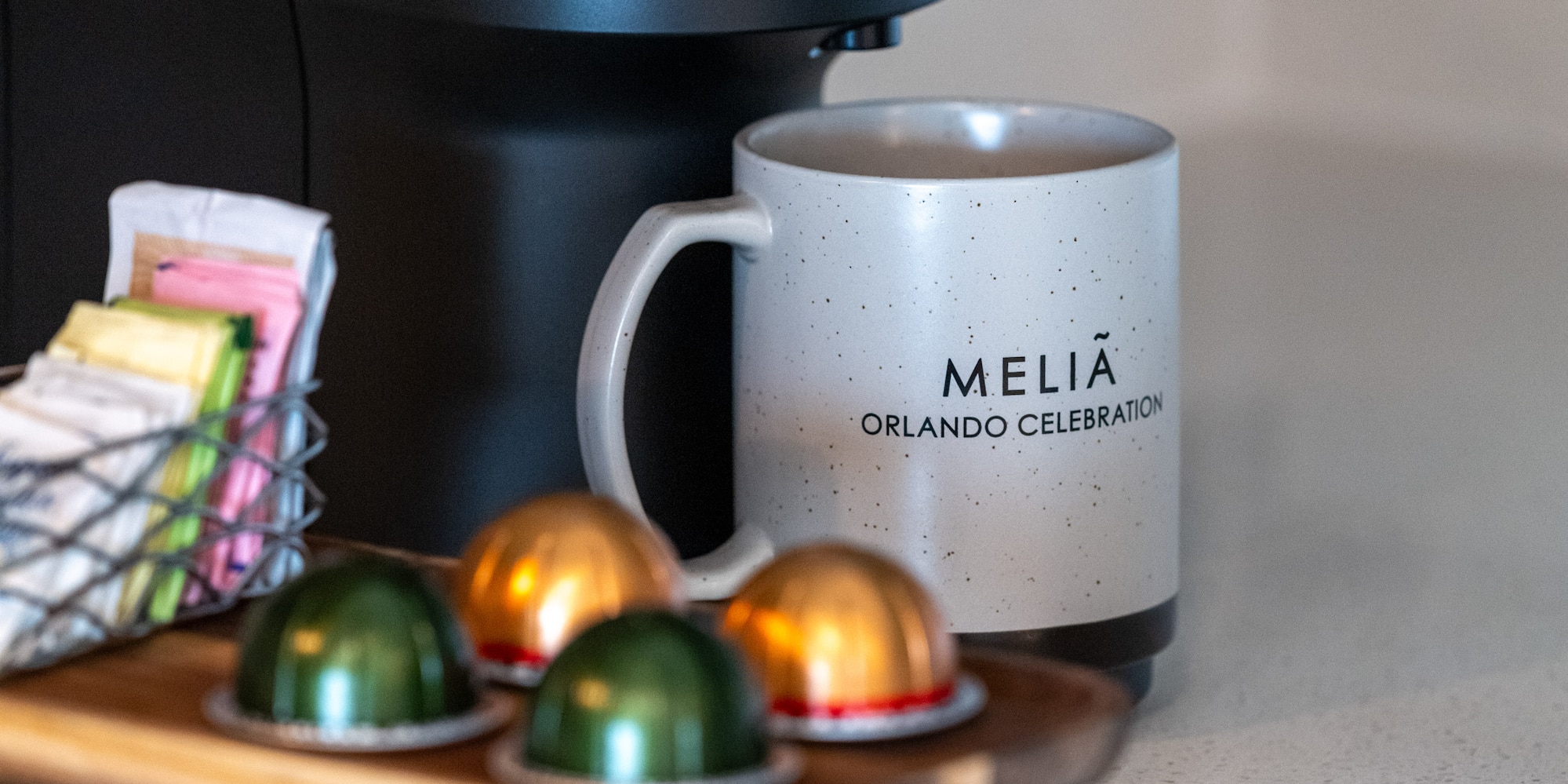 a coffee machine with a mug and some colorful capsules