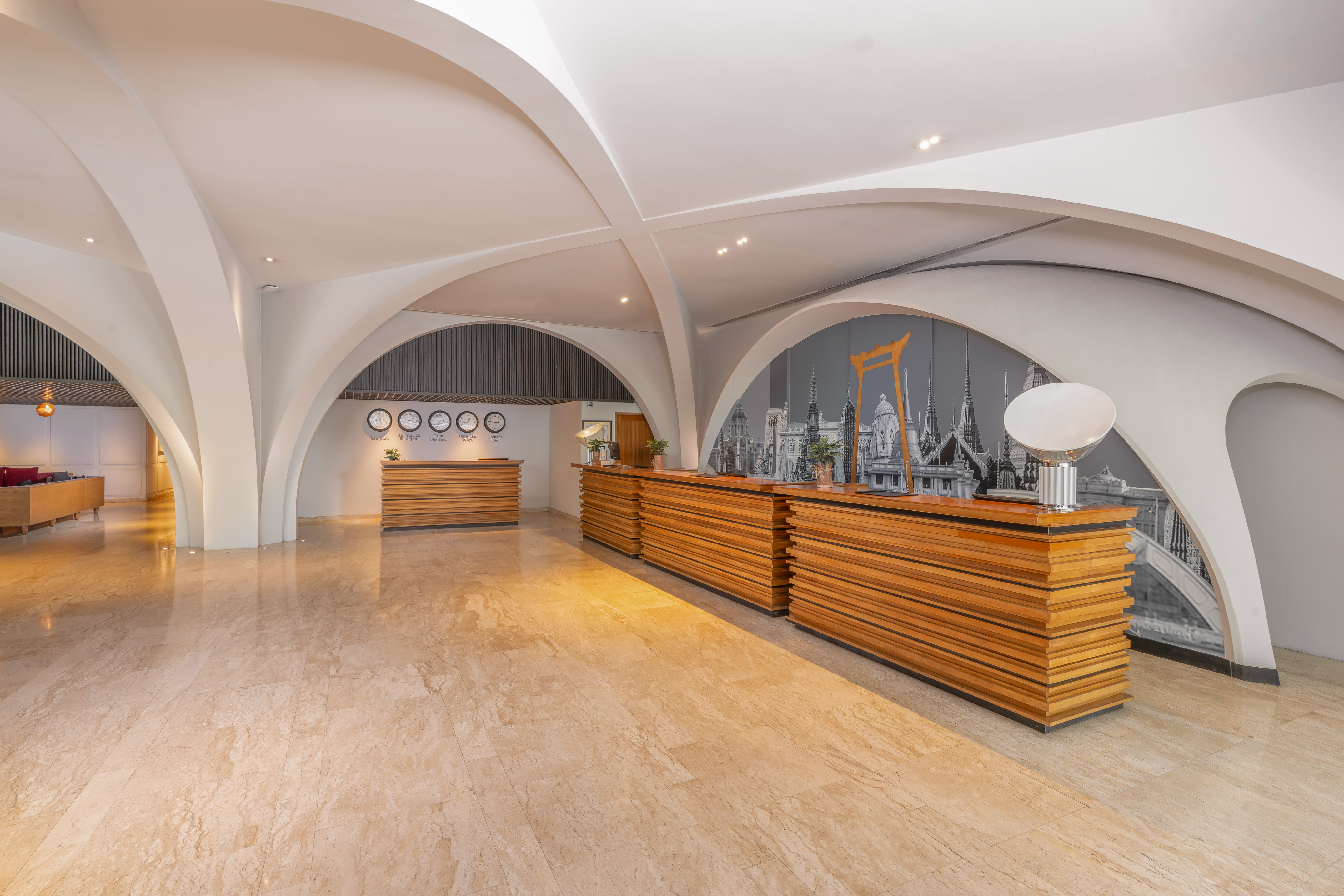 Modern hotel reception lobby with wooden desks and arched architectural ceilings. - Temukan Bangkok - Bangkok Sukhumvit 26, Bangkok