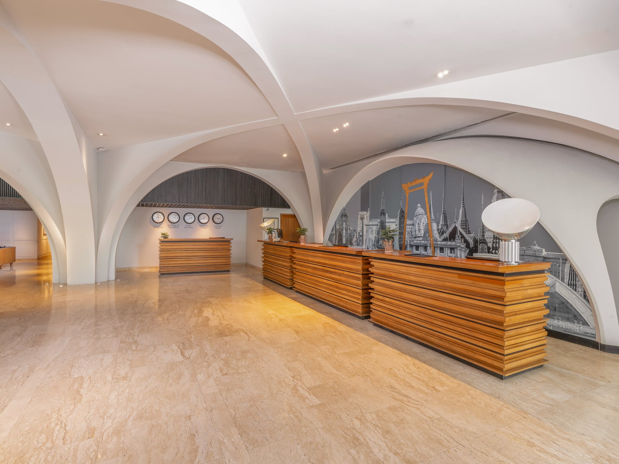 Modern hotel reception lobby with wooden desks and arched architectural ceilings. - Temukan Bangkok - Bangkok Sukhumvit 26, Bangkok