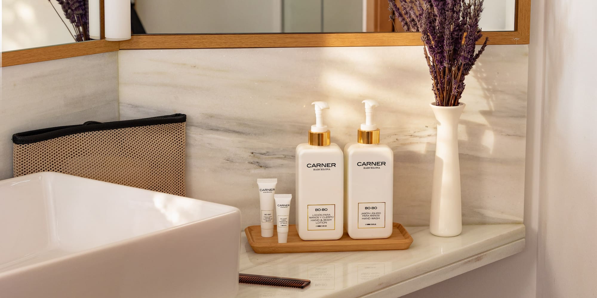 Carner Barcelona hand wash, body lotion, lavender on marble bathroom vanity.