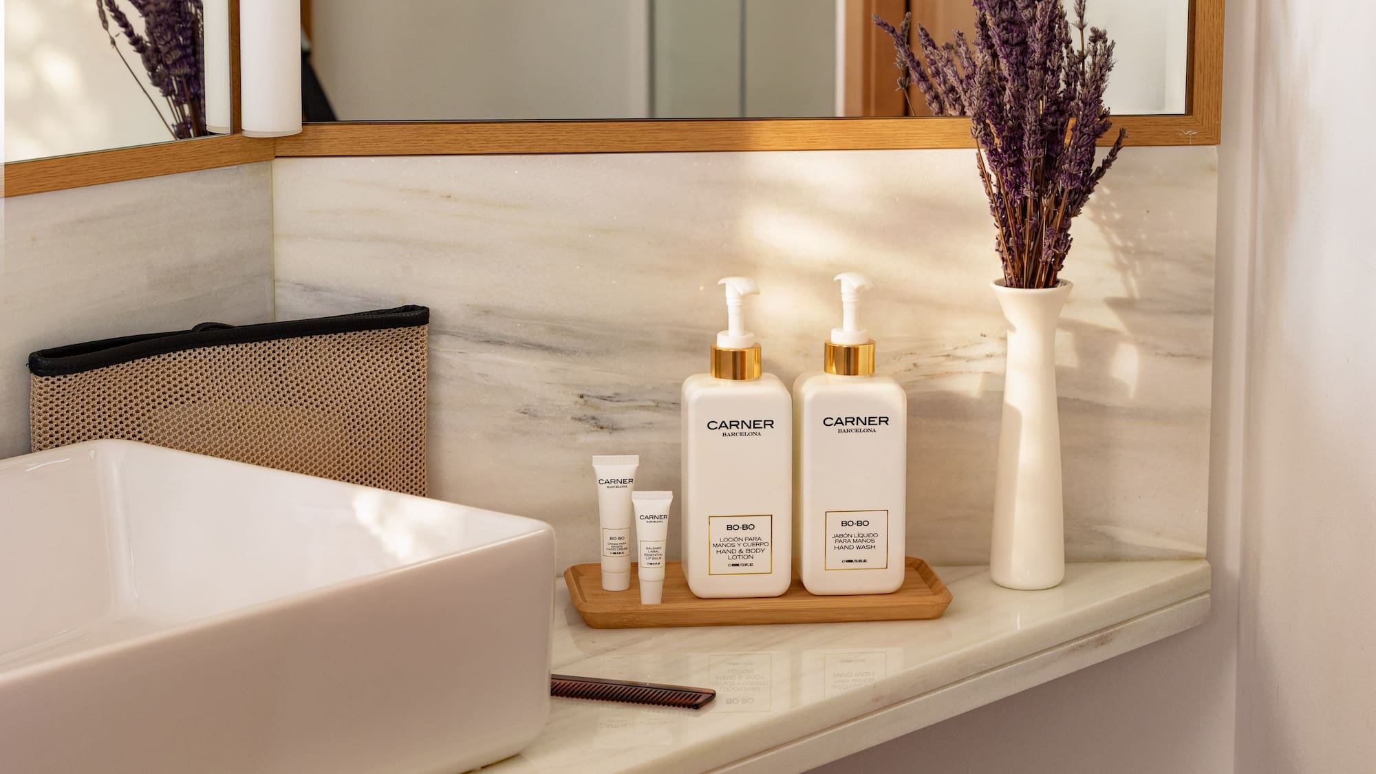 Carner Barcelona hand wash, body lotion, lavender on marble bathroom vanity.