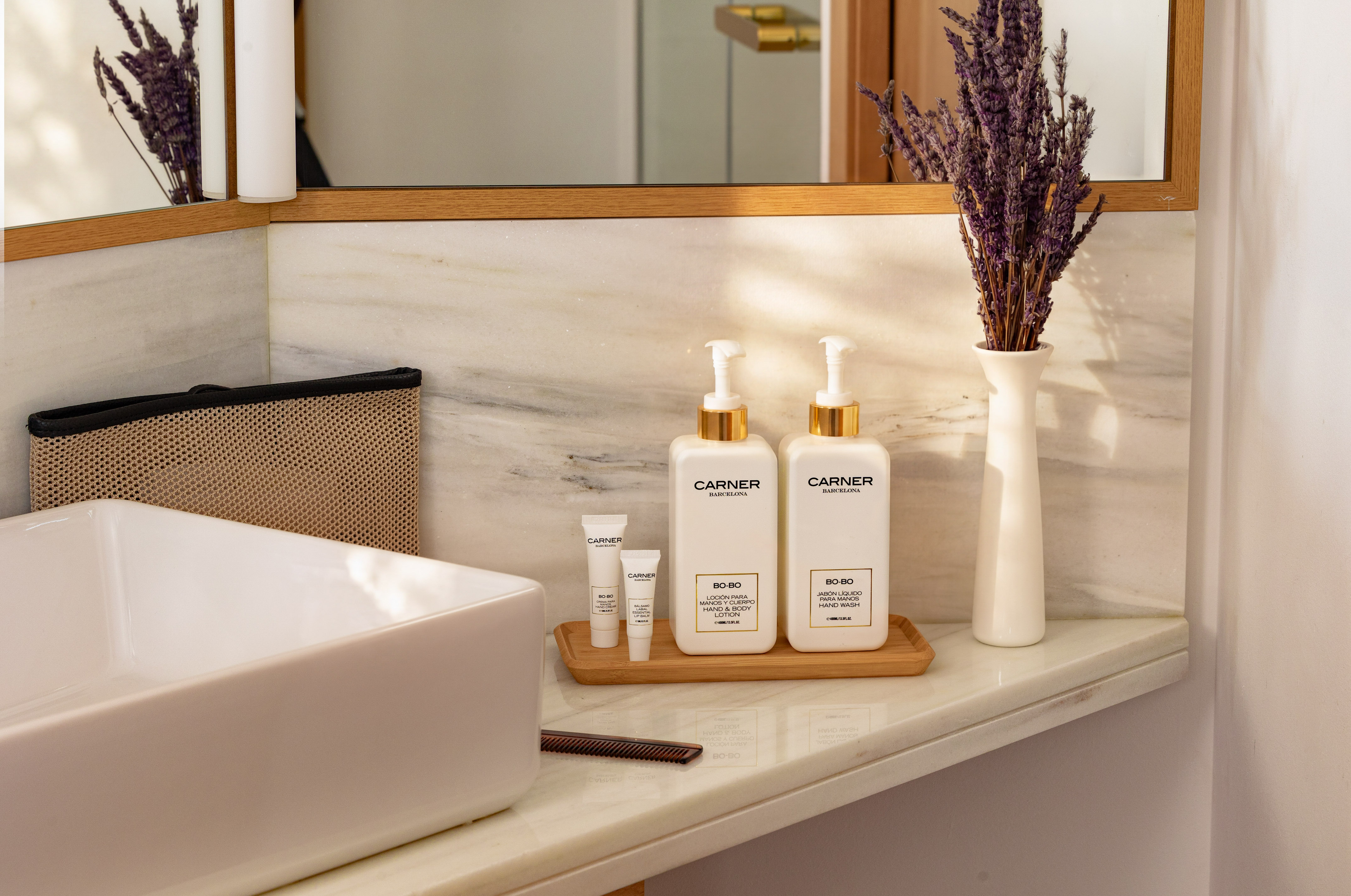Carner Barcelona hand wash, body lotion, lavender on marble bathroom vanity.