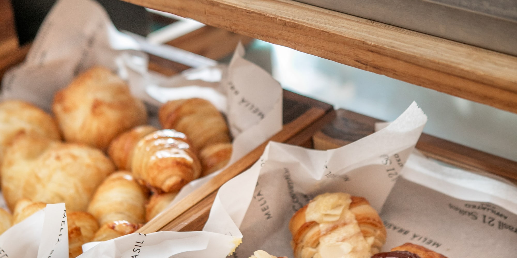 Hotel breakfast buffet with savory cold cuts, cheeses, and sweet pastries.