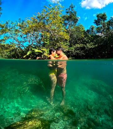 a man and woman kissing under water