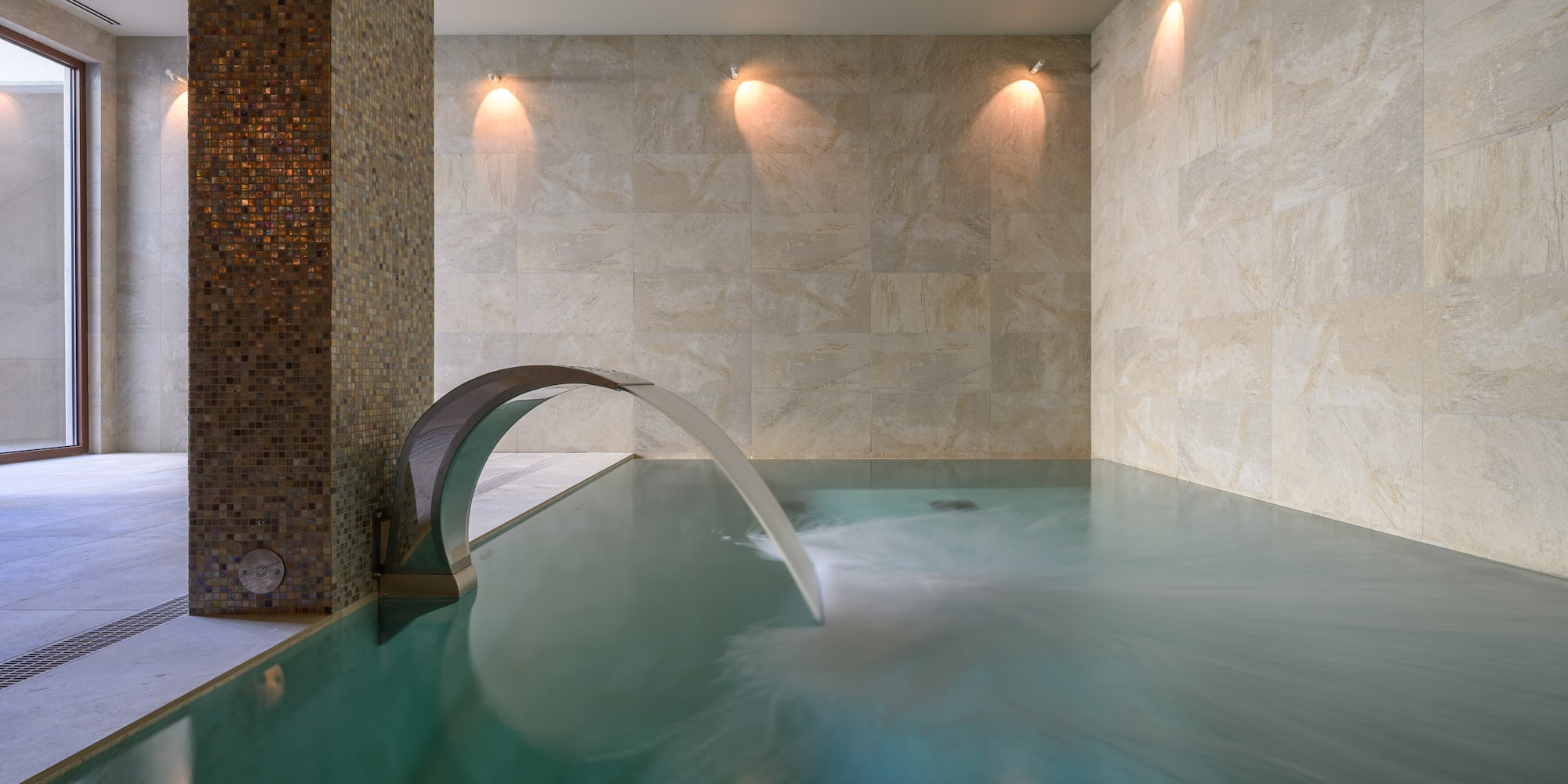 a pool with a waterfall