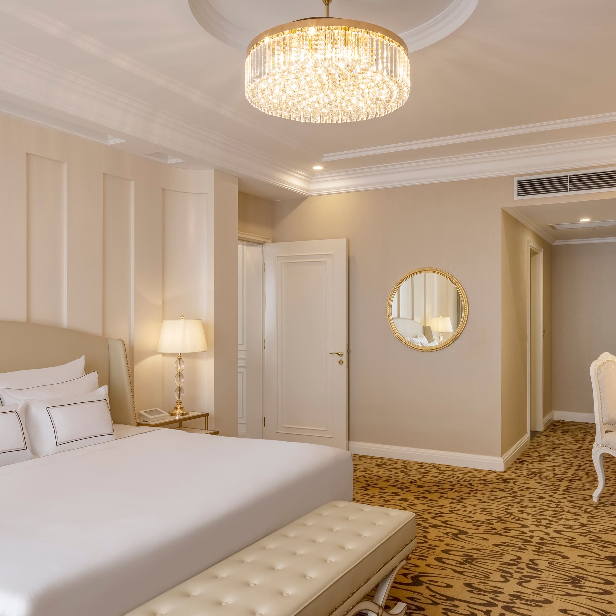 a bedroom with a chandelier and a bed