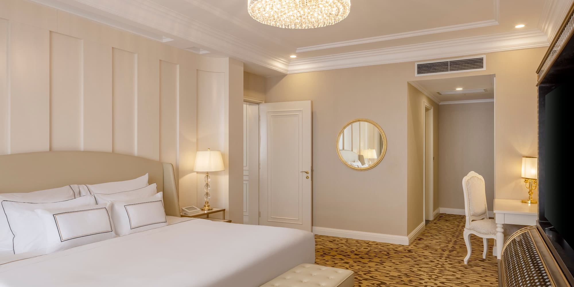 a bedroom with a chandelier and a bed