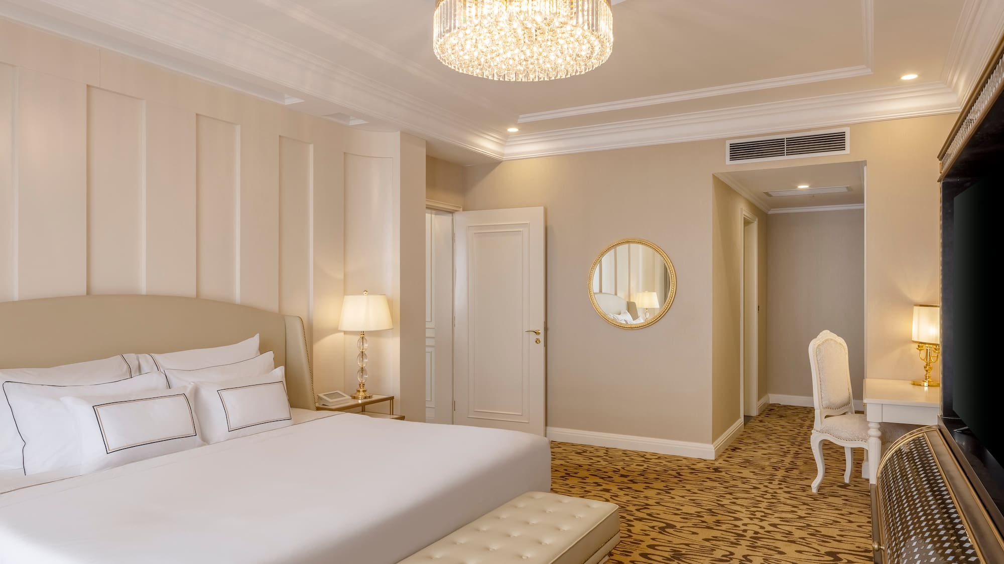 a bedroom with a chandelier and a bed