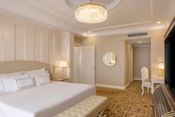 a bedroom with a chandelier and a bed