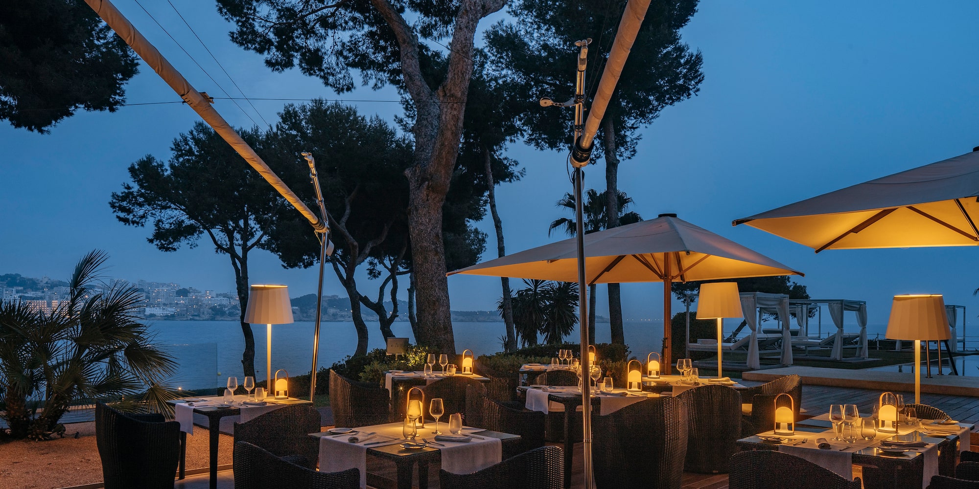 a table with candles and umbrellas on a patio