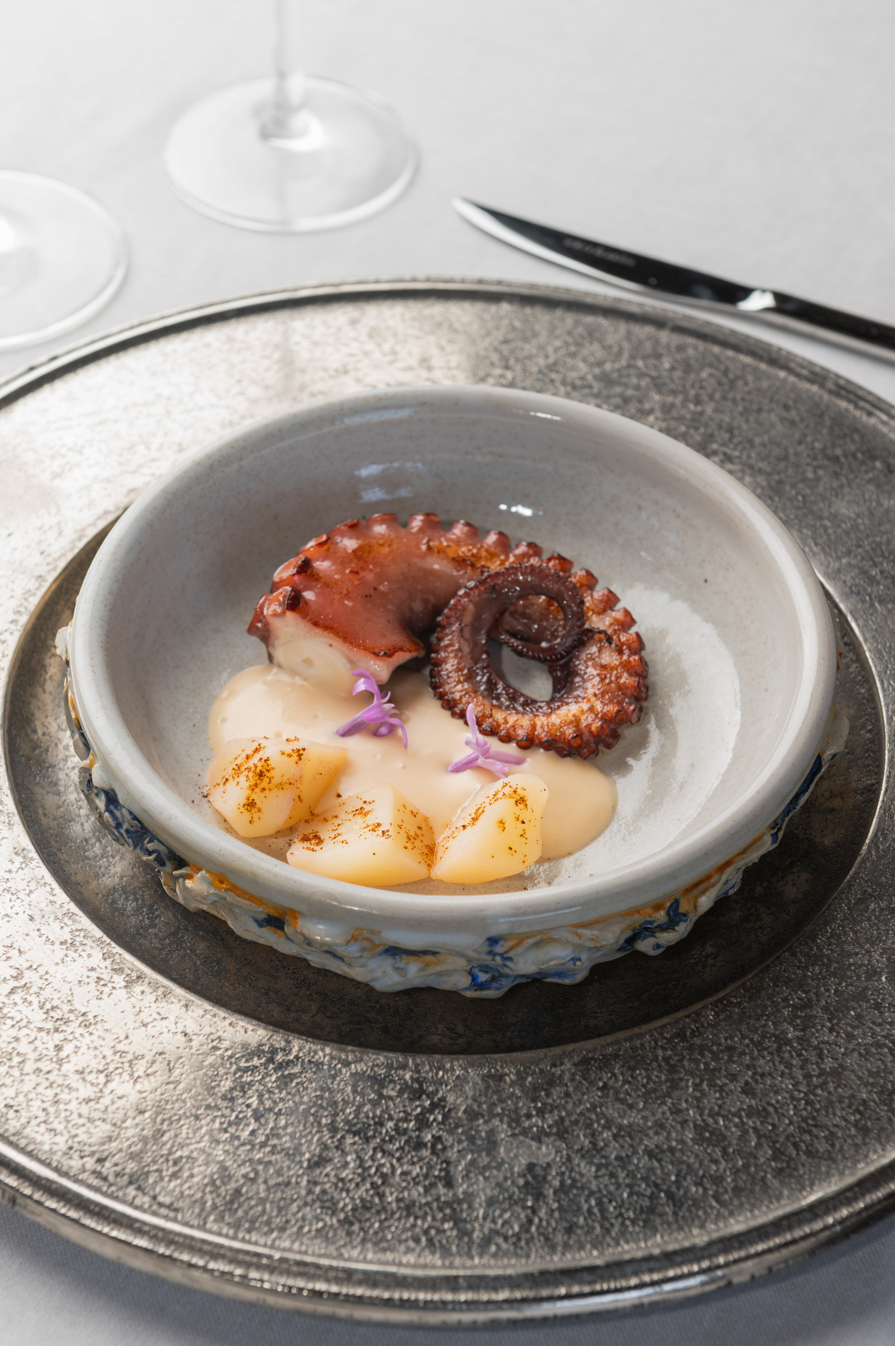 Gourmet grilled octopus and scallops with creamy sauce.