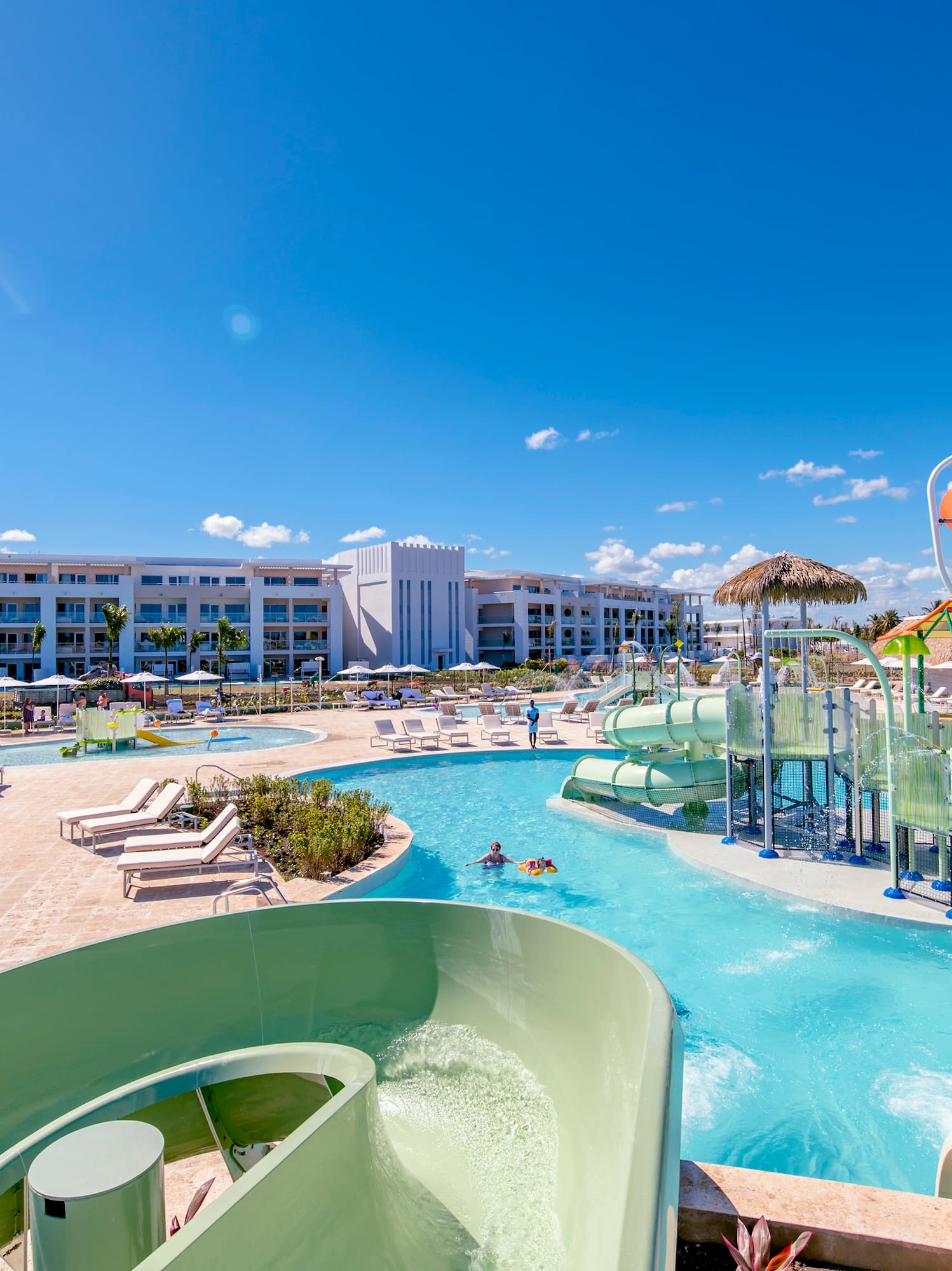 a water park with a slide and a pool