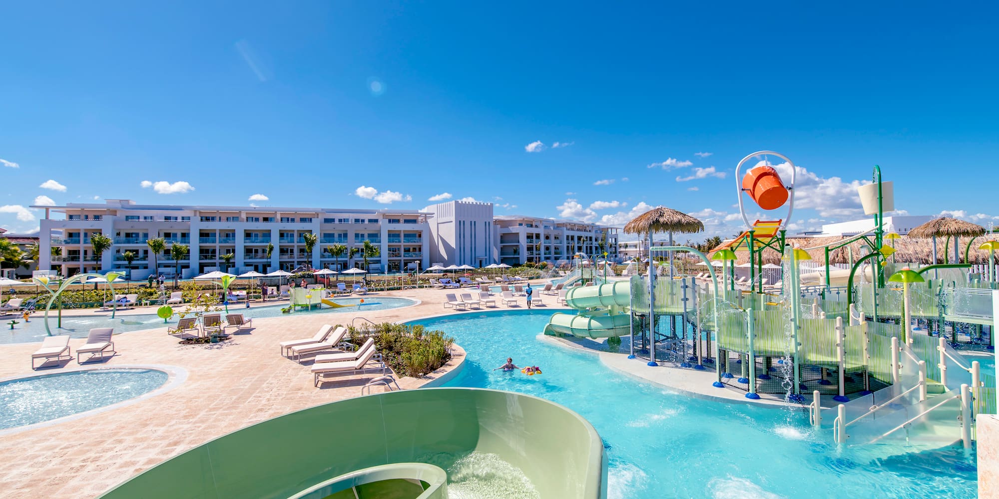 a water park with a slide and a pool