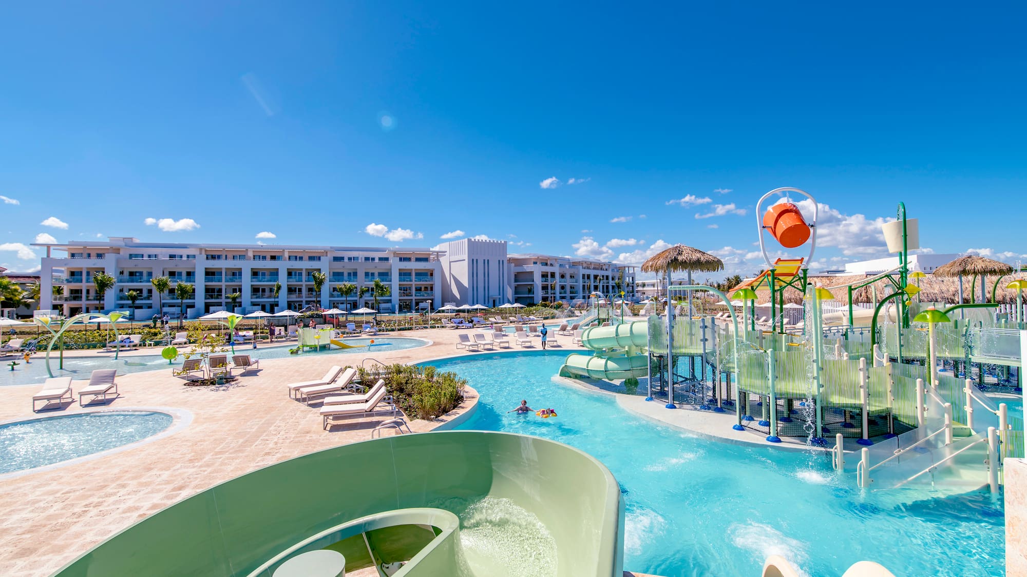 a water park with a slide and a pool