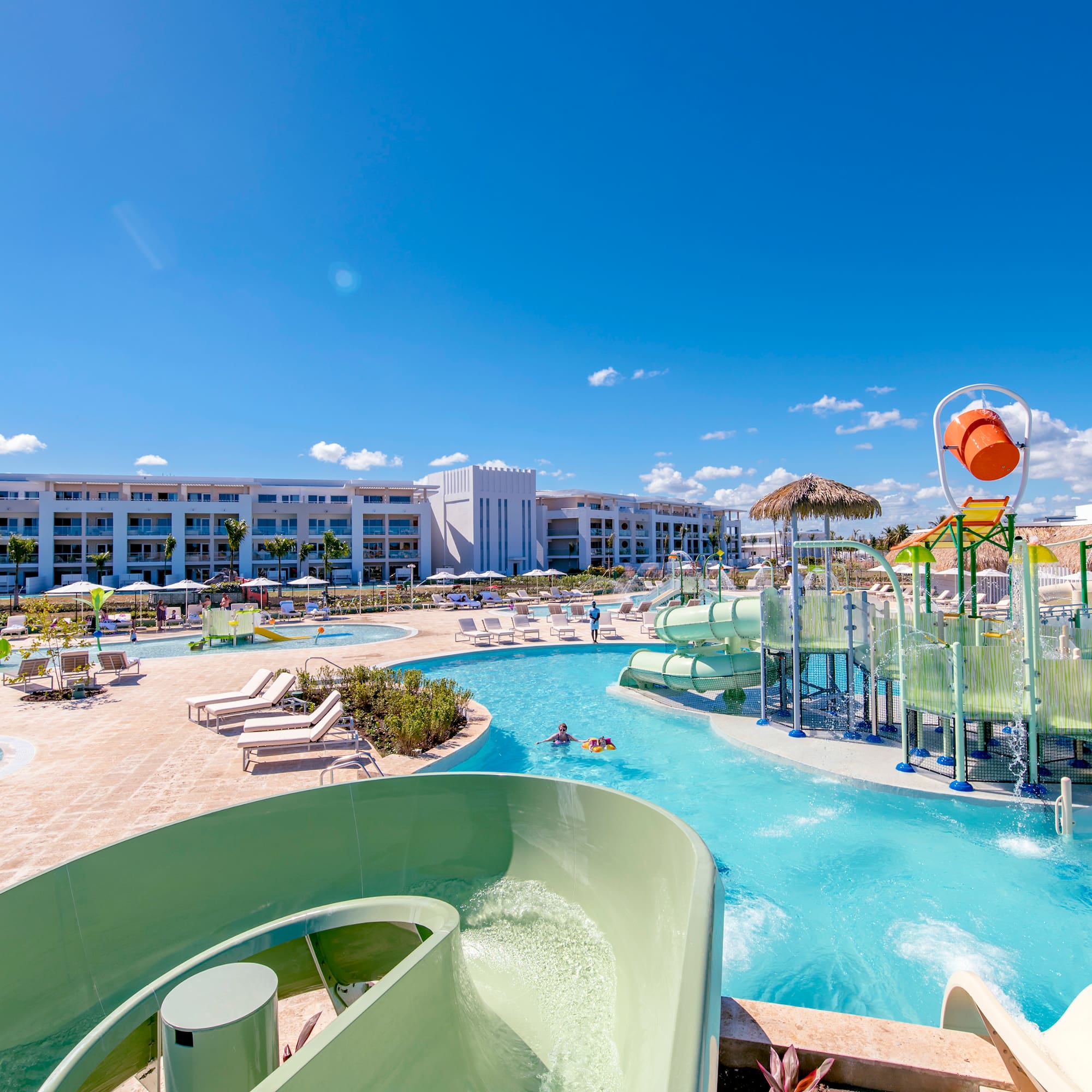 a water park with a slide and a pool