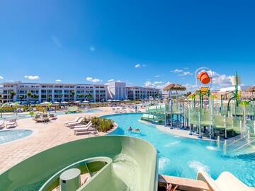 a water park with a slide and a pool