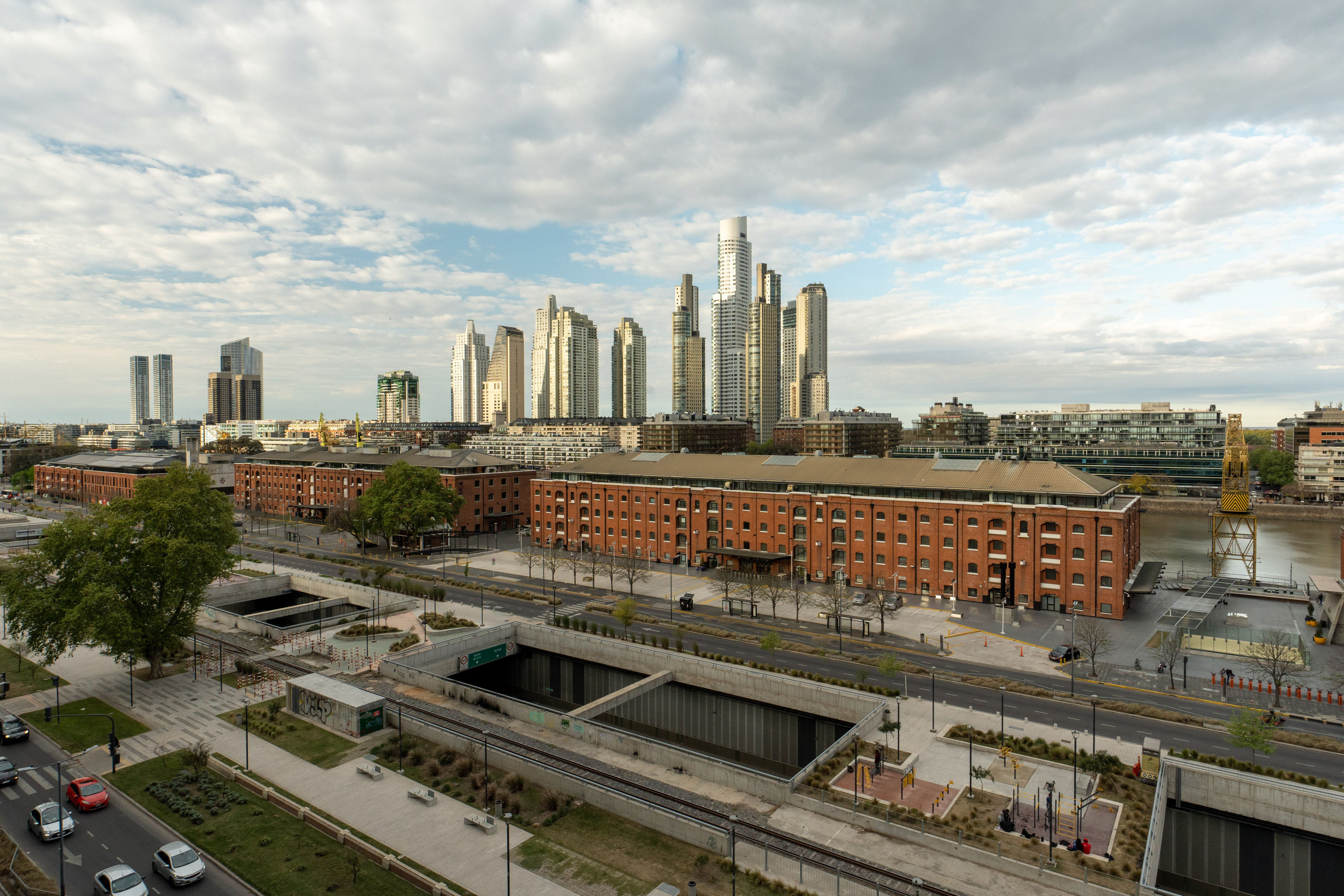 Puerto Madero, Buenos Aires cityscape with skyscrapers, historic brick buildings, docks, and roads.