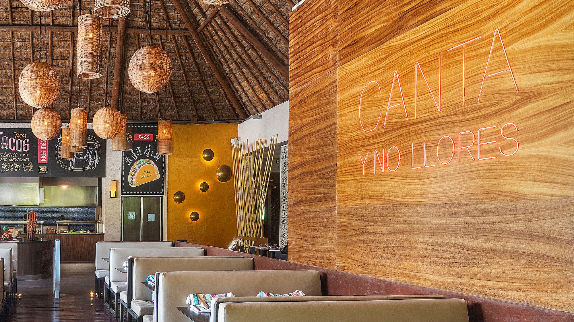 a restaurant with a large wall and tables