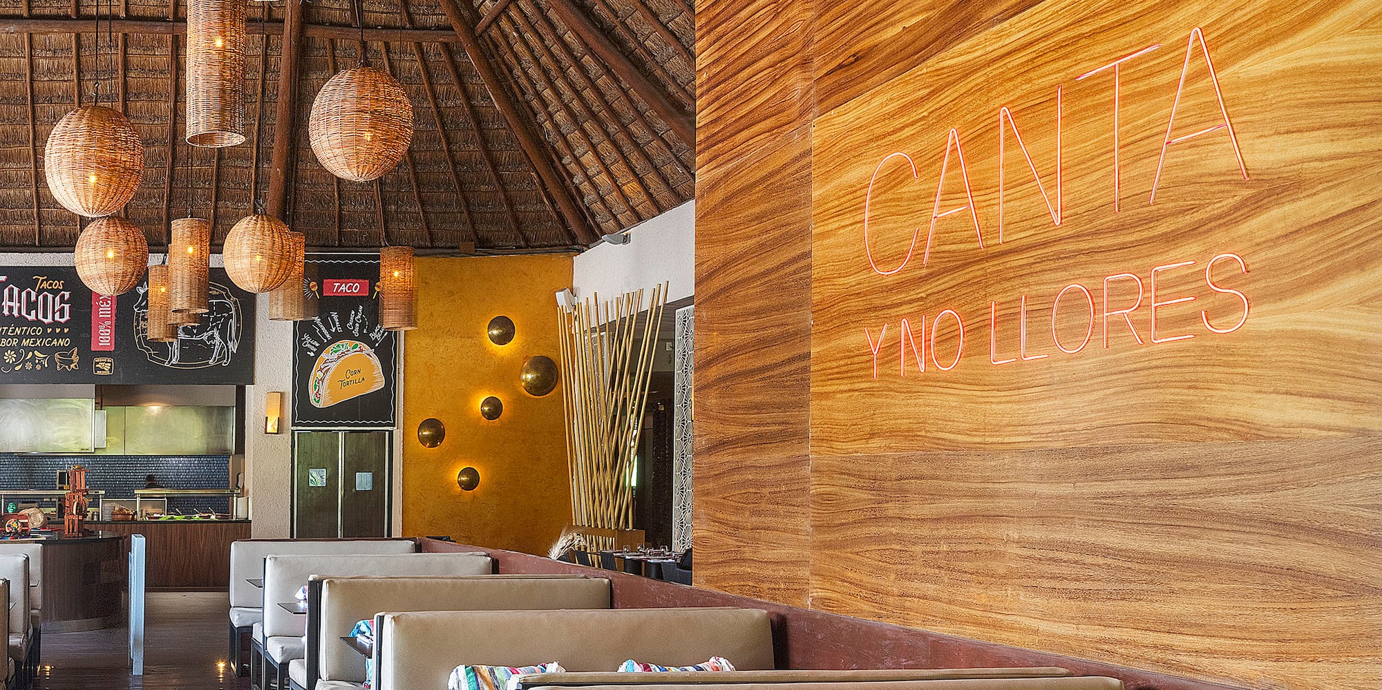 a restaurant with a large wall and tables