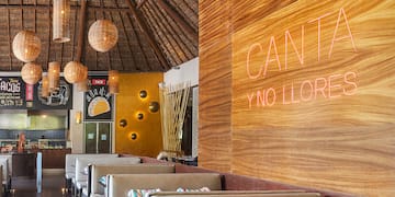 a restaurant with a large wall and tables