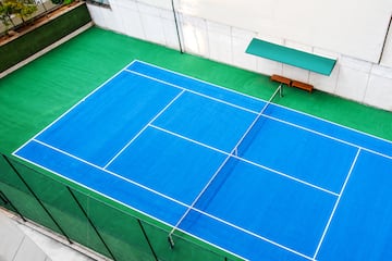 a tennis court with a bench and a bench
