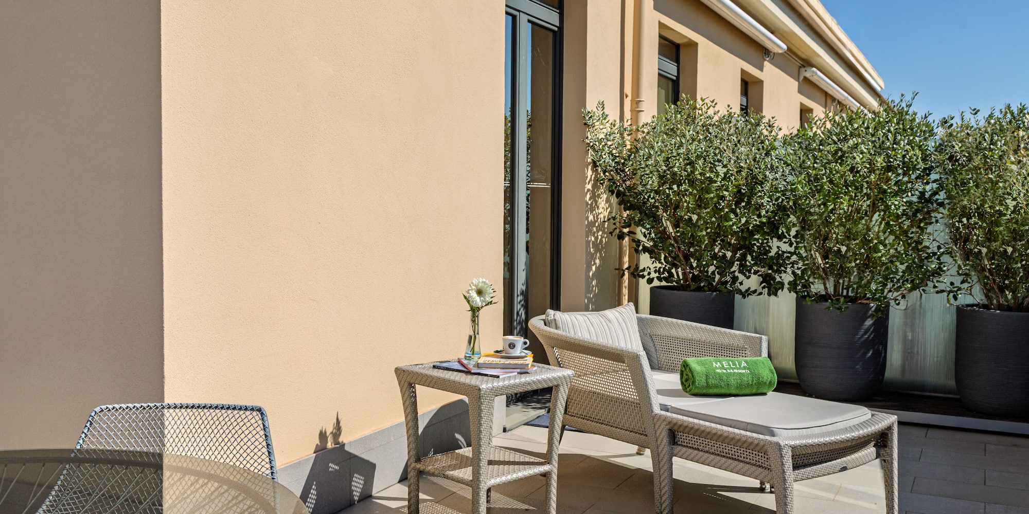 a patio with chairs and a table