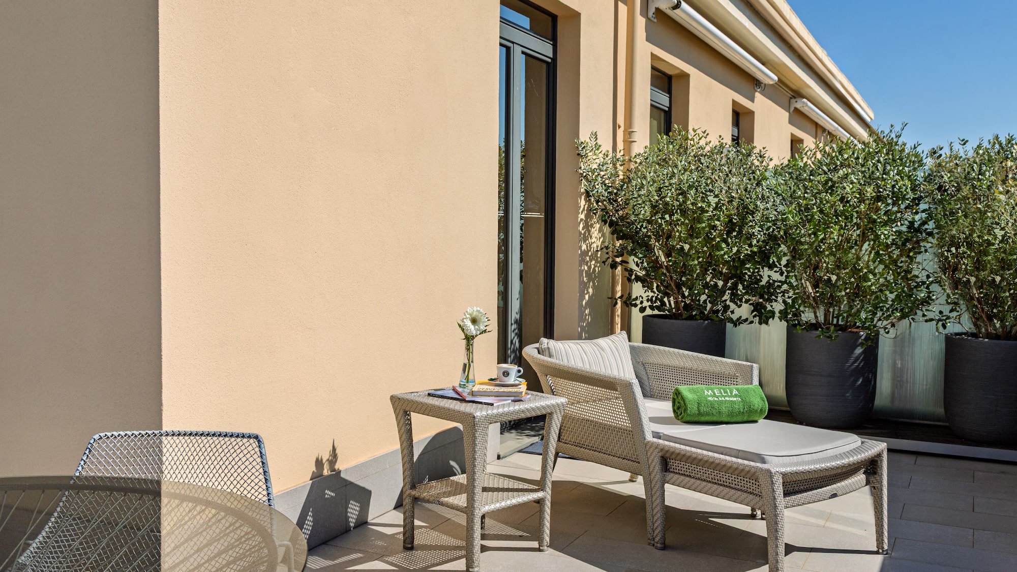 a patio with chairs and a table