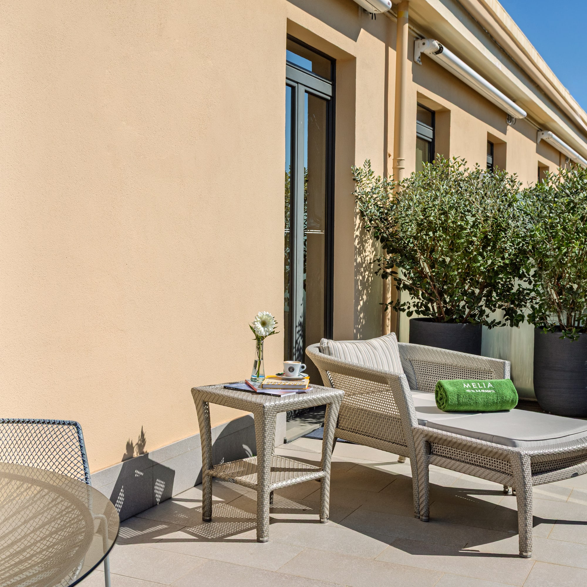 a patio with chairs and a table