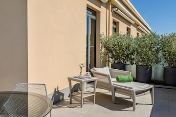 a patio with chairs and a table