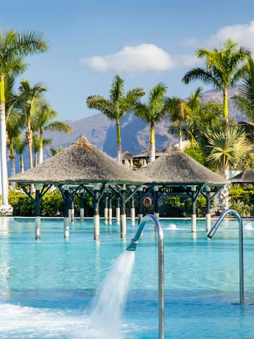 a pool with water jets and trees