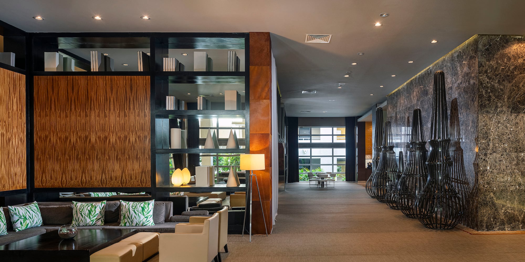 a room with a large wall and a large shelf with chairs and a table