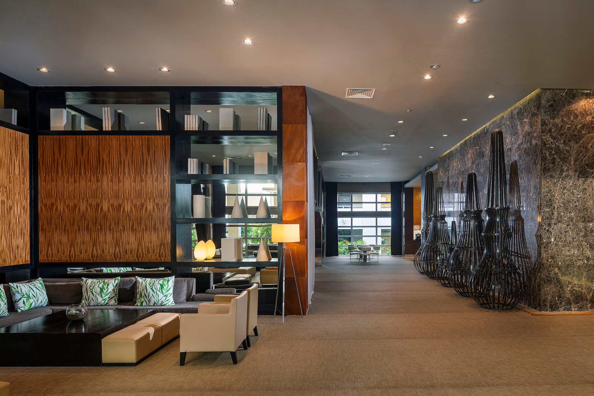 a room with a large wall and a large shelf with chairs and a table