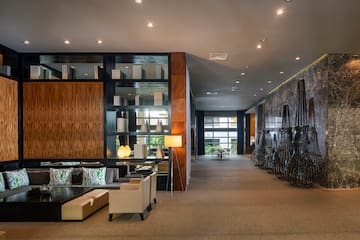 a room with a large wall and a large shelf with chairs and a table