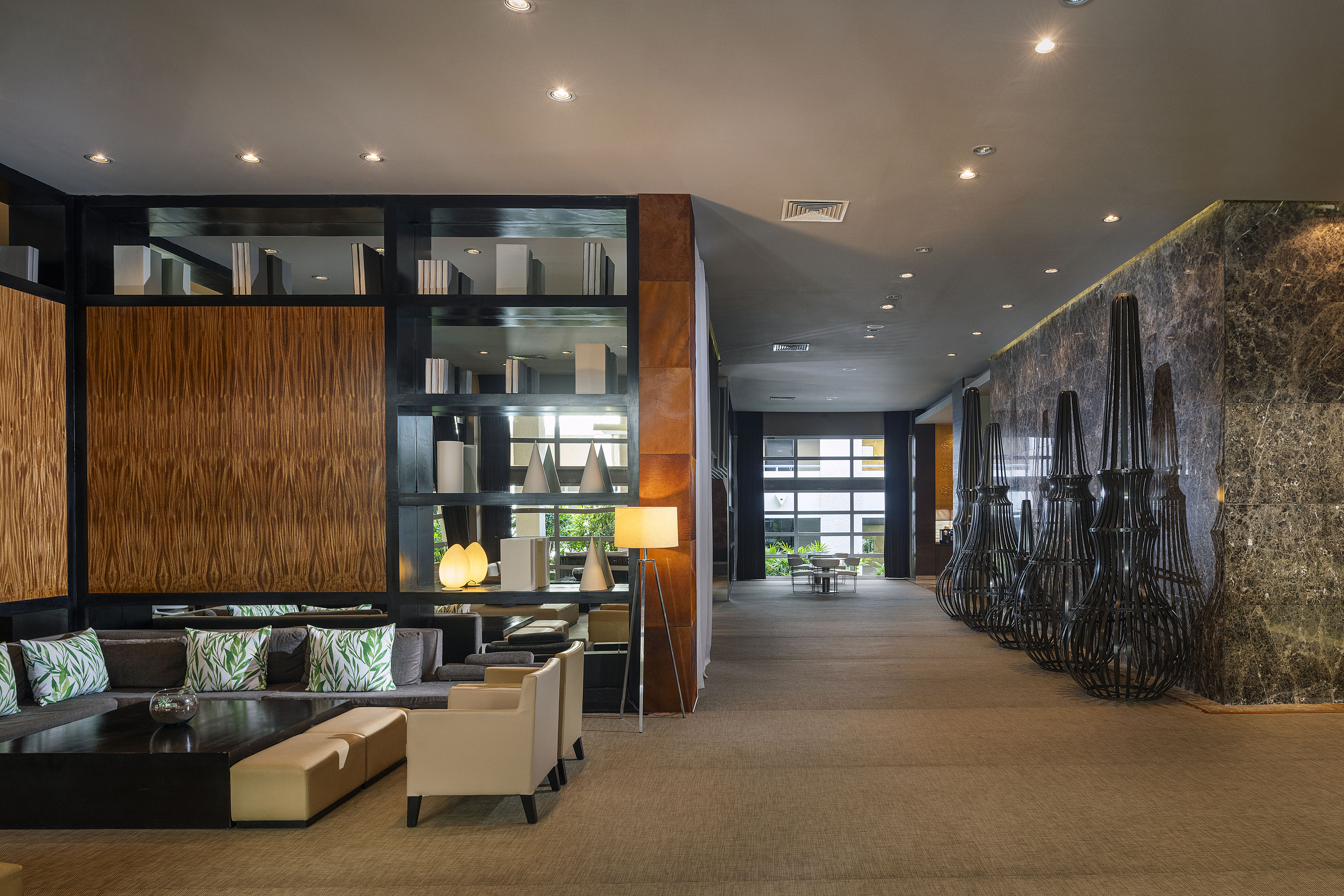 a room with a large wall and a large shelf with chairs and a table
