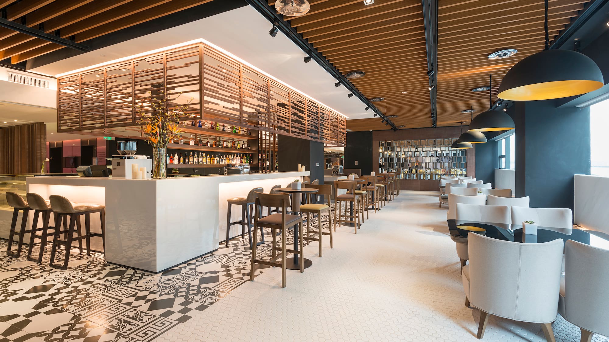 a room with a bar and chairs