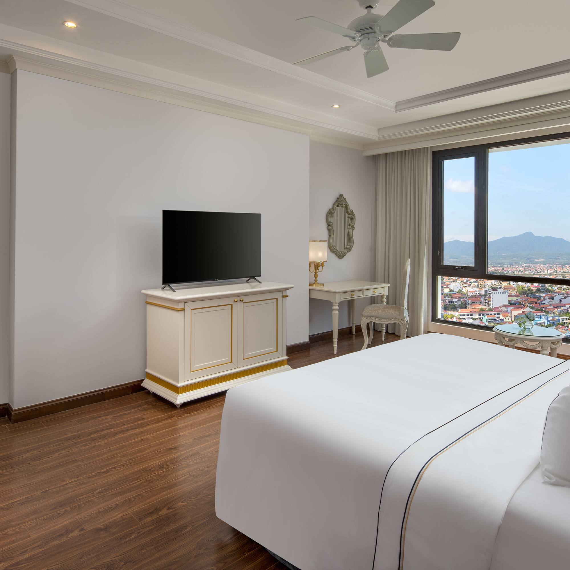 a room with a large window and a bed