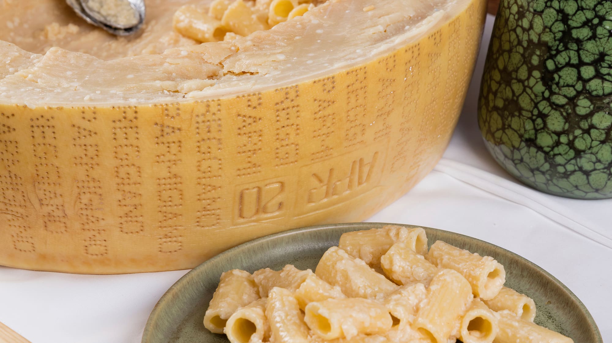 a wheel of cheese and pasta on a plate