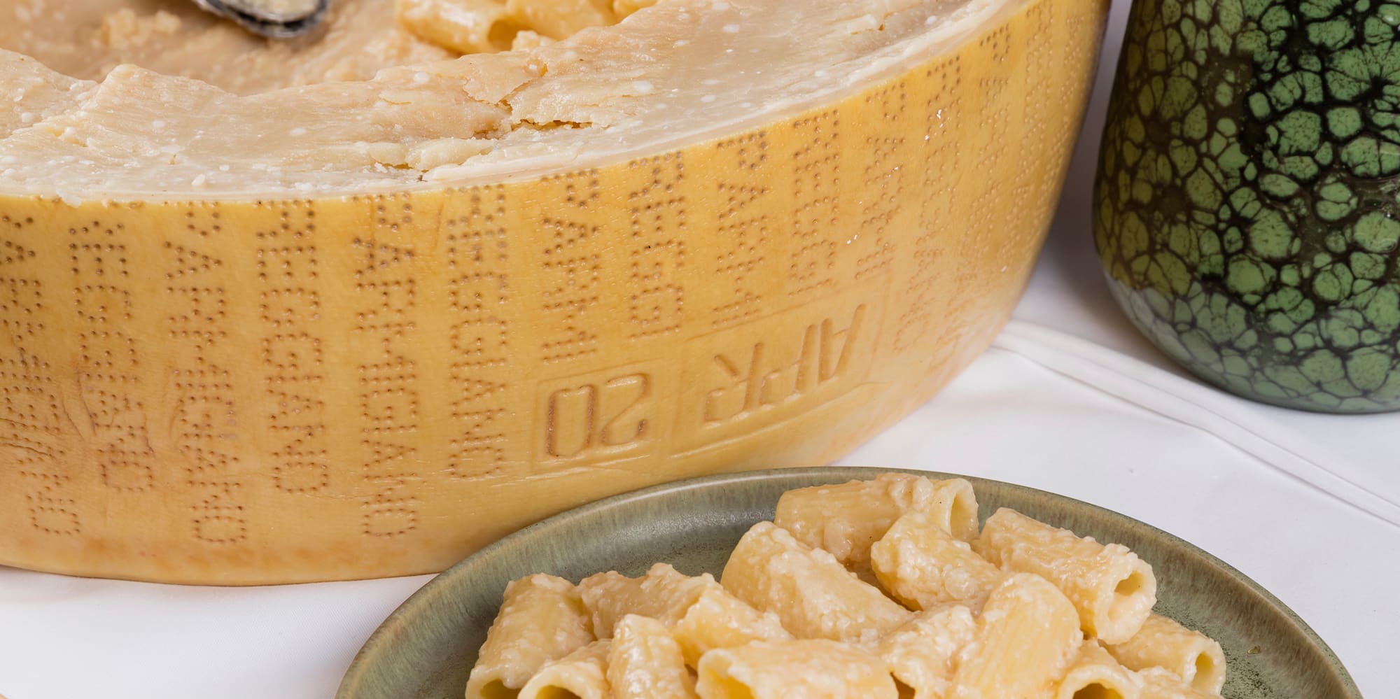 a wheel of cheese and pasta on a plate