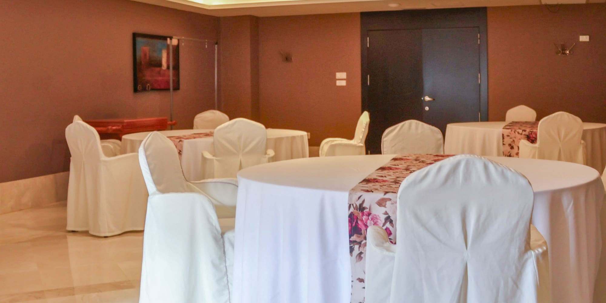 a room with round tables and chairs