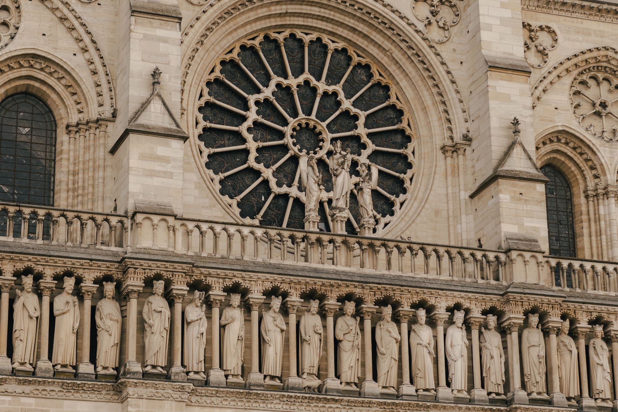 a large stone building with statues on the side