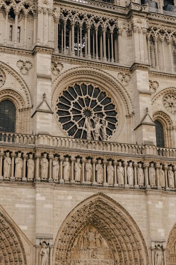 a large stone building with statues on the side