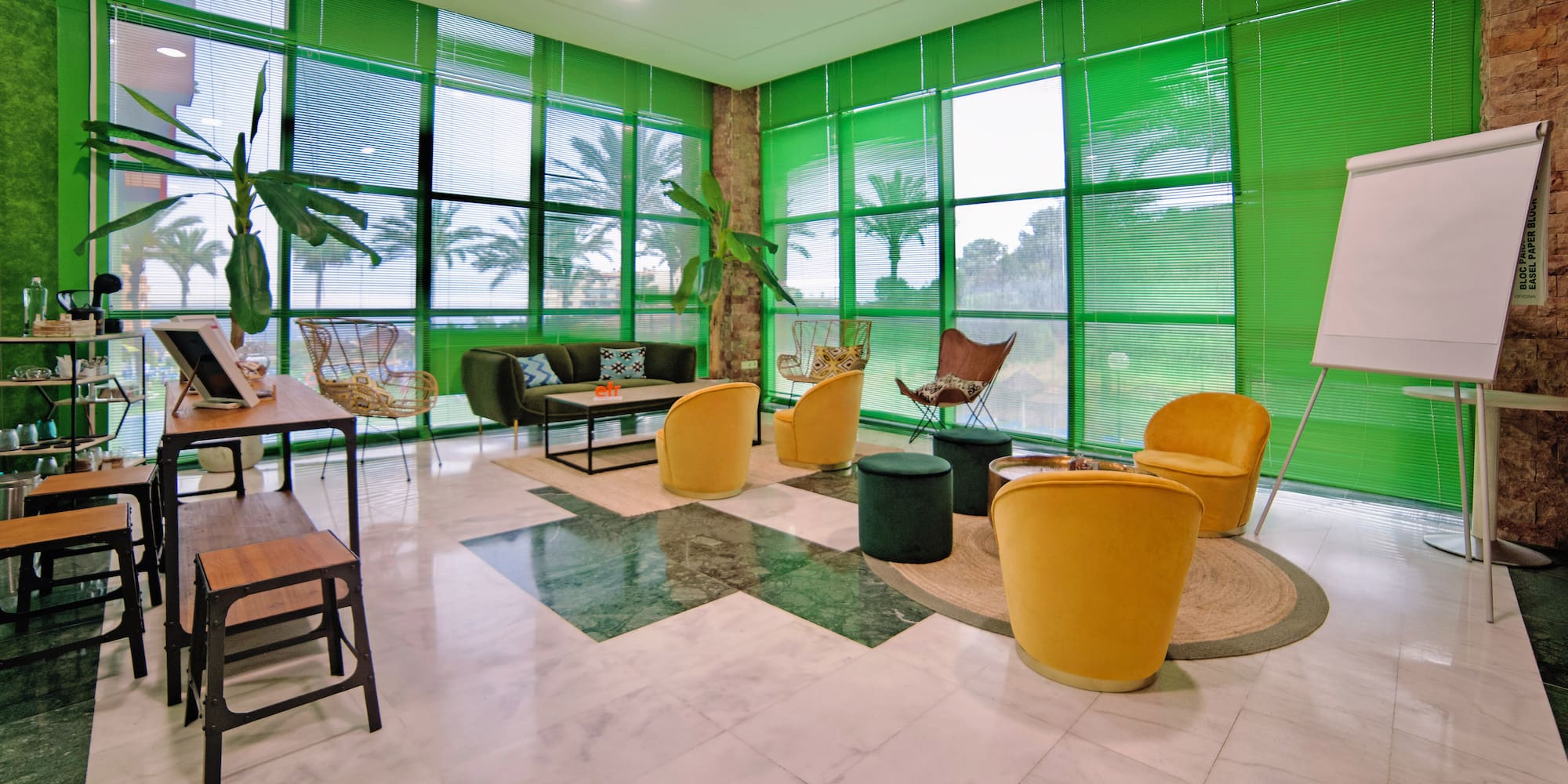 a room with green walls and a green wall with a green wall and a green couch and chairs